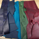 Colorful crazy horse leather arranged on a wooden surface.