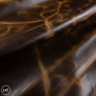 Close-up of brown dark honey leather with a subtle pattern