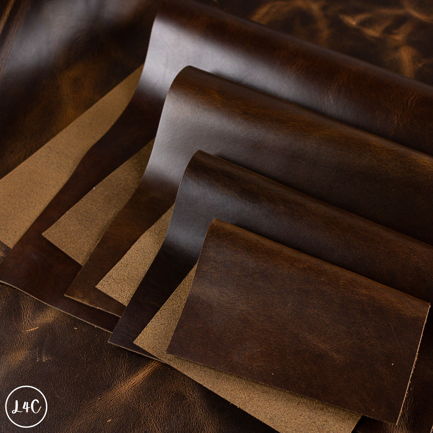 Brown dark honey leather sheets on a wooden surface