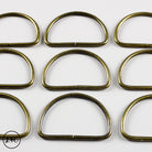 Bronze metal rings arranged in a grid on a white background