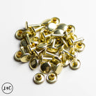 Gold metal rivets on a white background