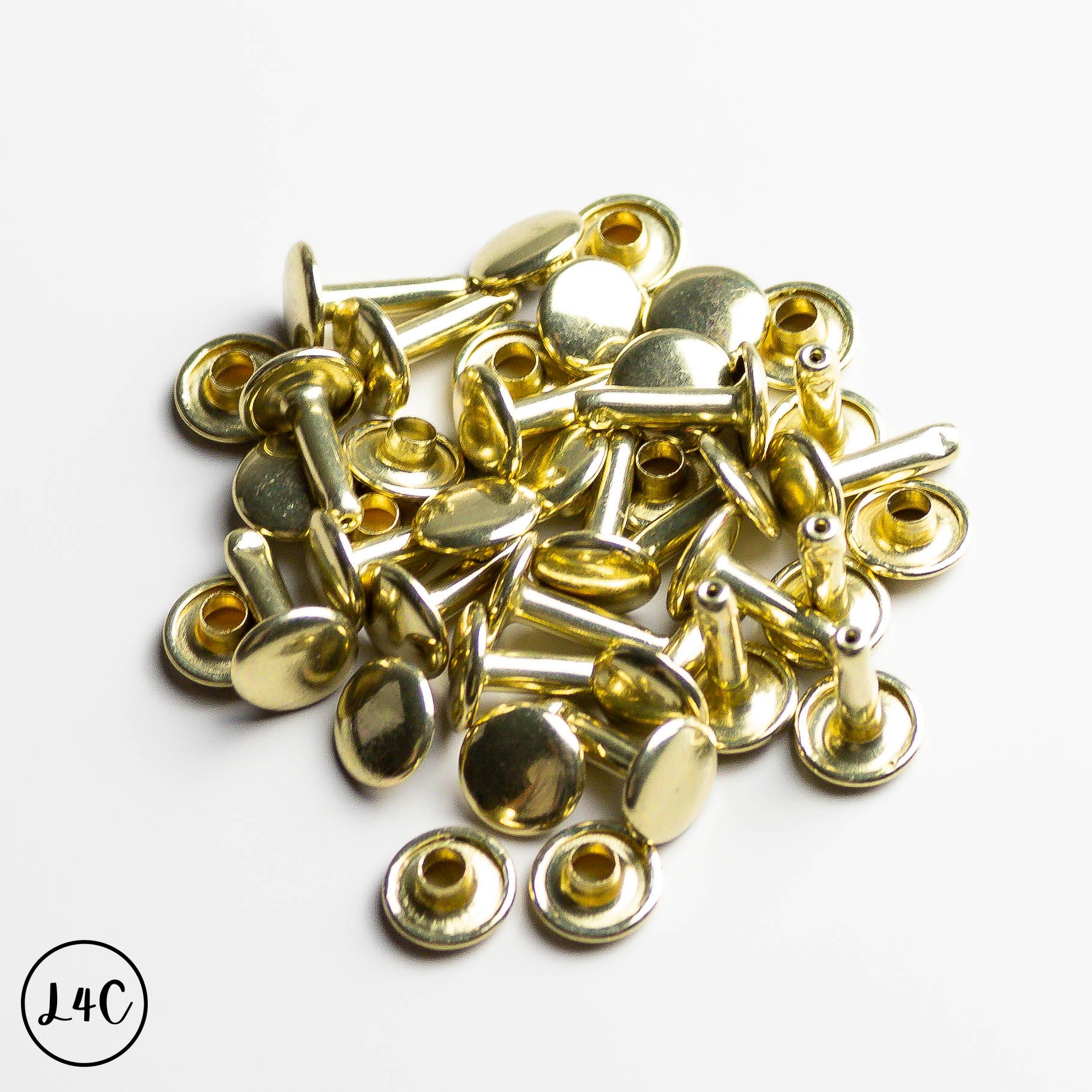 Gold metal rivets on a white background