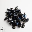 Collection of black and silver metal Double Cap Rivets on a white background
