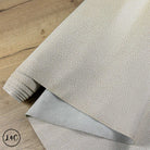 Textured leather Tipped Epsom Grain Leather Hide on a wooden surface with a visible brand logo.