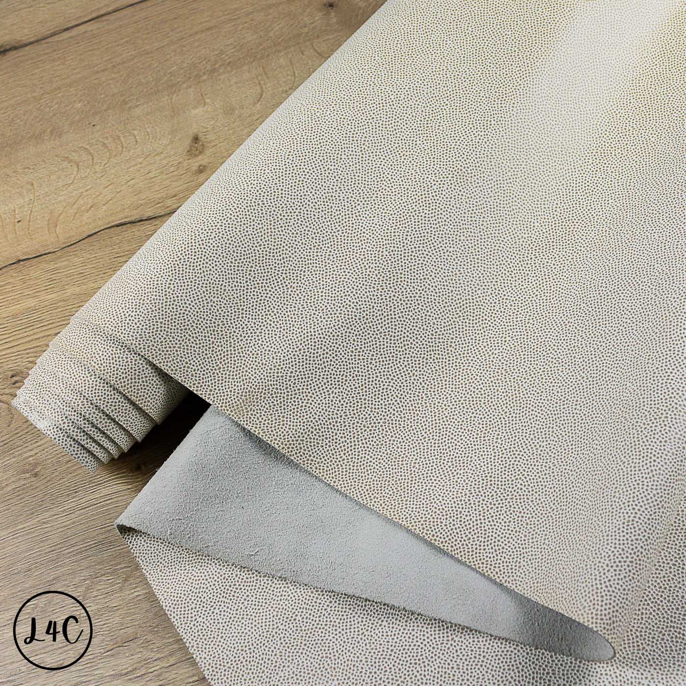 Textured leather Tipped Epsom Grain Leather Hide on a wooden surface with a visible brand logo.