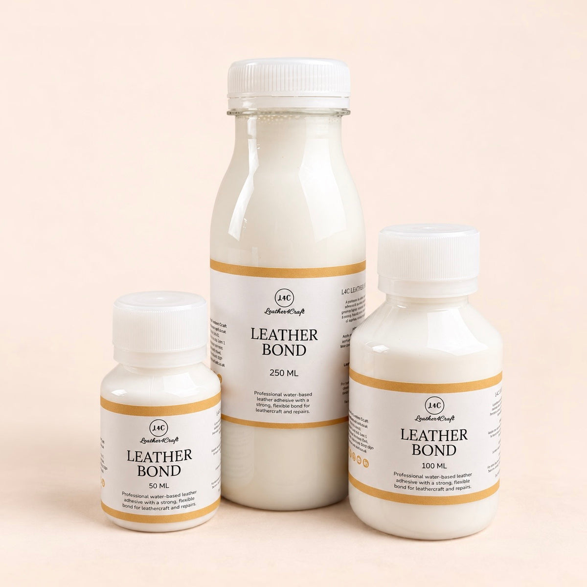Three bottles of Leather Bond adhesive  in different sizes, arranged on a solid pale peach background.