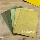 Collection of leather with 'Backing' text on a wooden surface