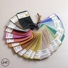 Color swatch card with various fabric samples and labels on a light background