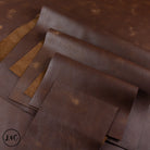 Brown leather hide with visible texture on a brown background