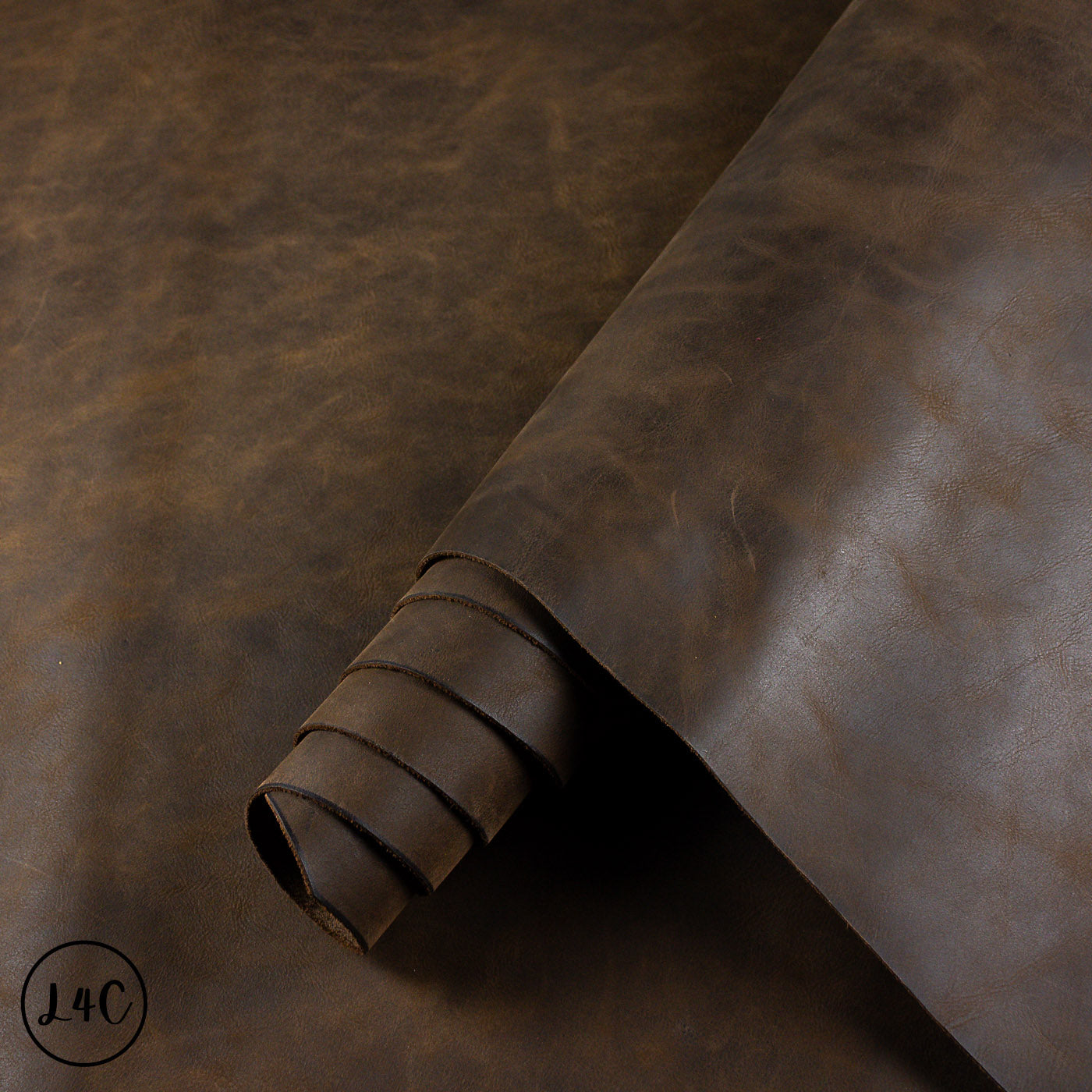 Brown leather hide roll on a dark brown background