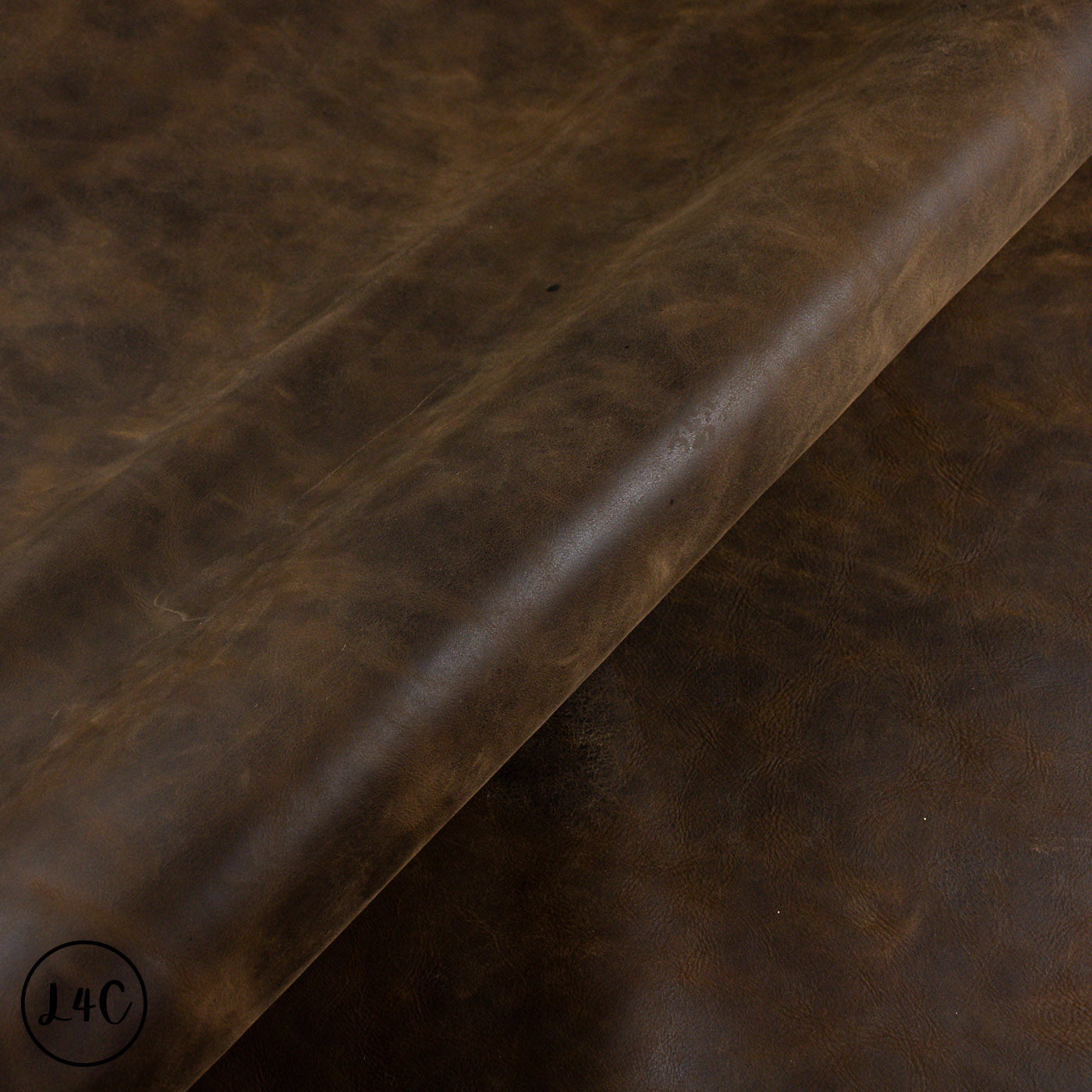 Brown leather hide with texture, visible grain and wear.
