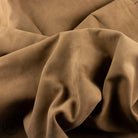 Close-up of brown leather hide with folds