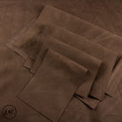 Brown leather panels on a brown leather surface.