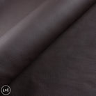 Close-up of dark brown leather with visible texture