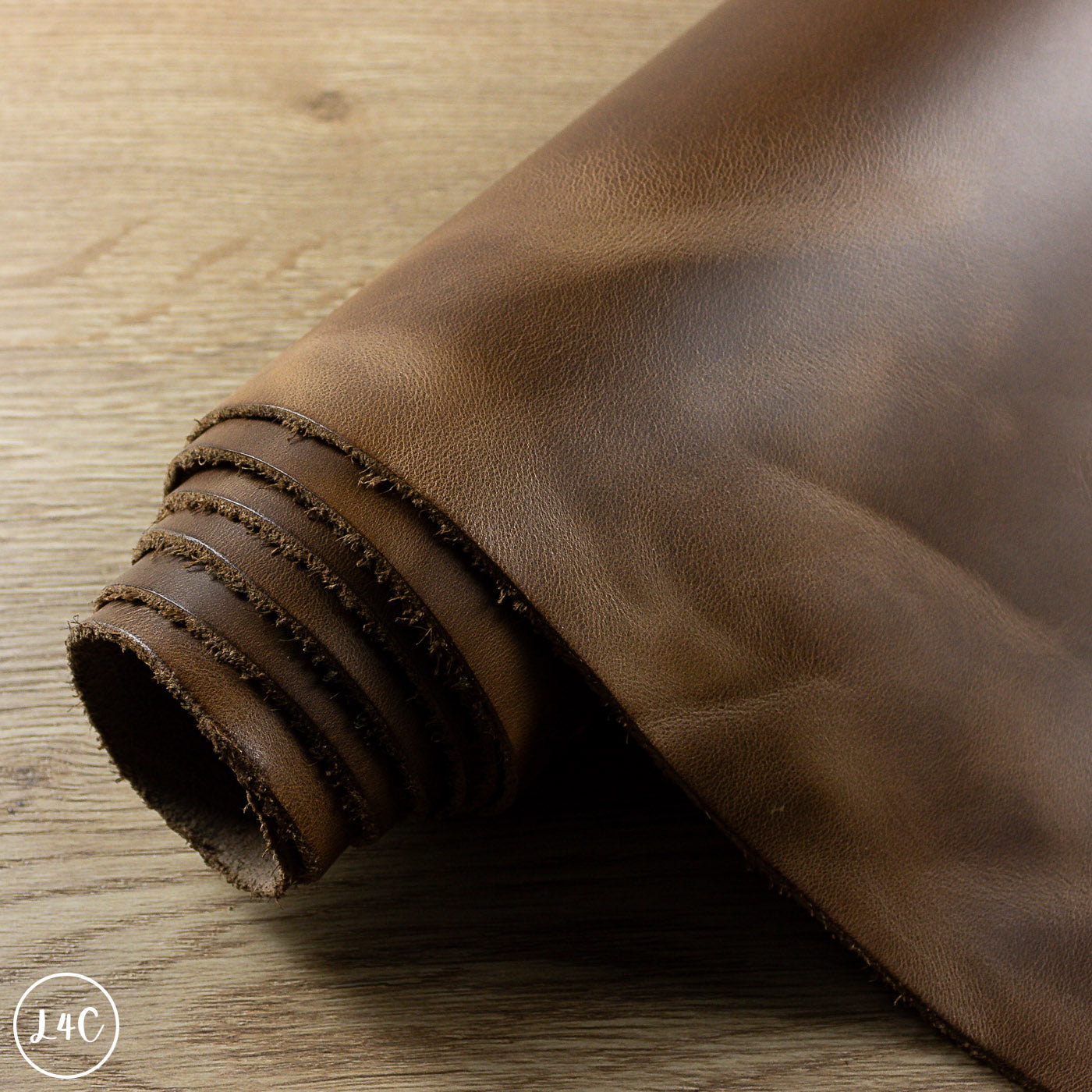 Rolled-up brown leather on a wooden surface