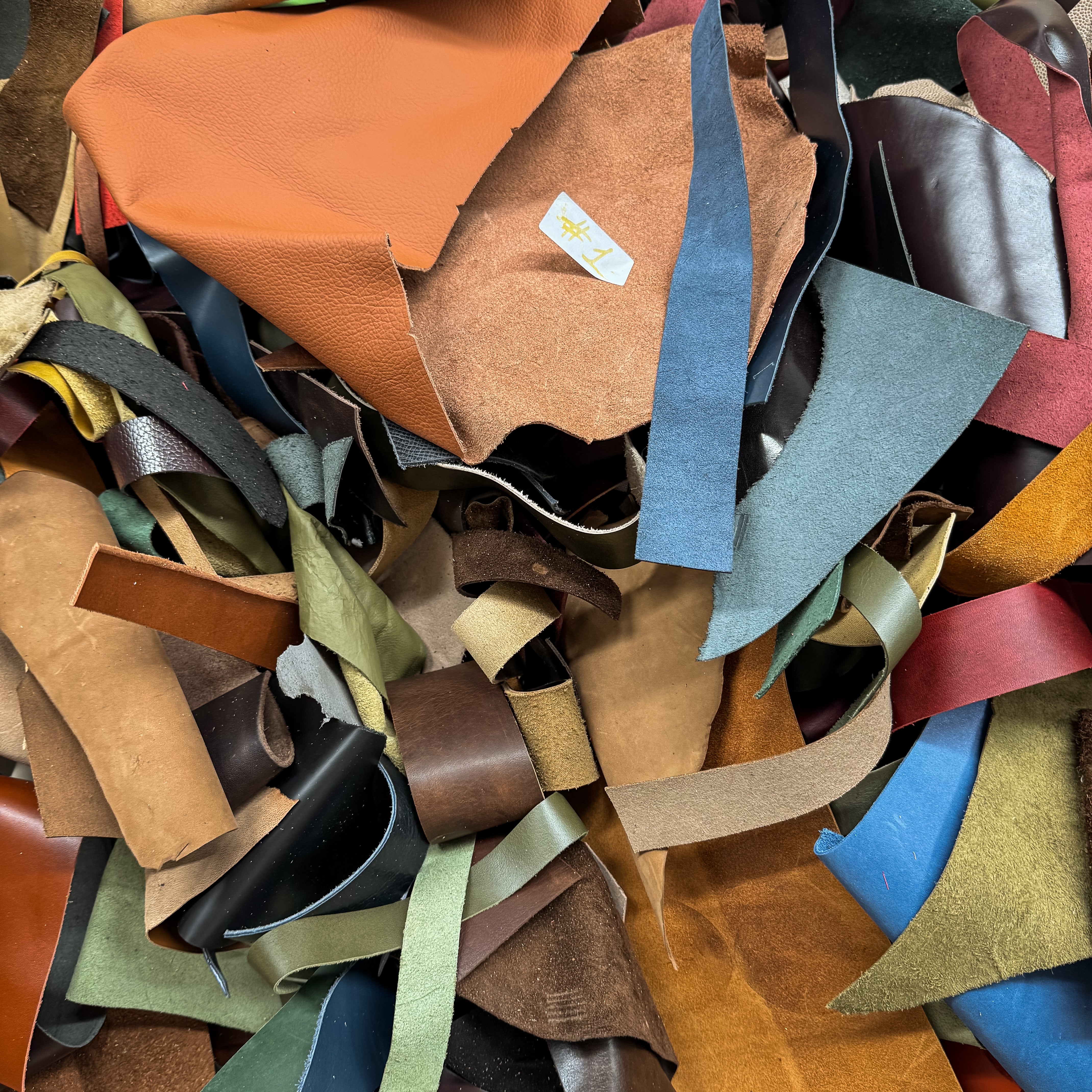 Collection of multicolored leather strips in various shades.