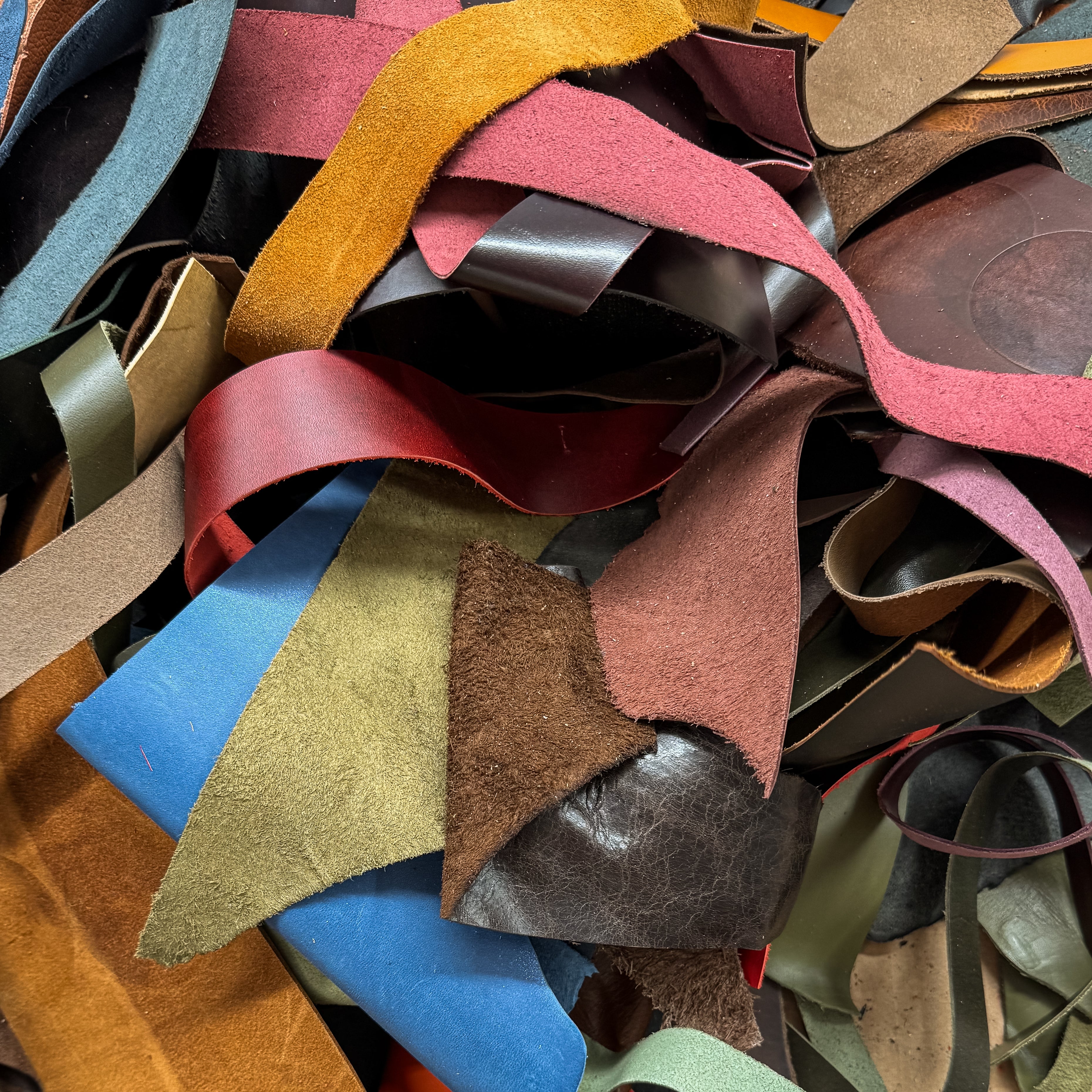 Assorted colorful leather strips in a pile
