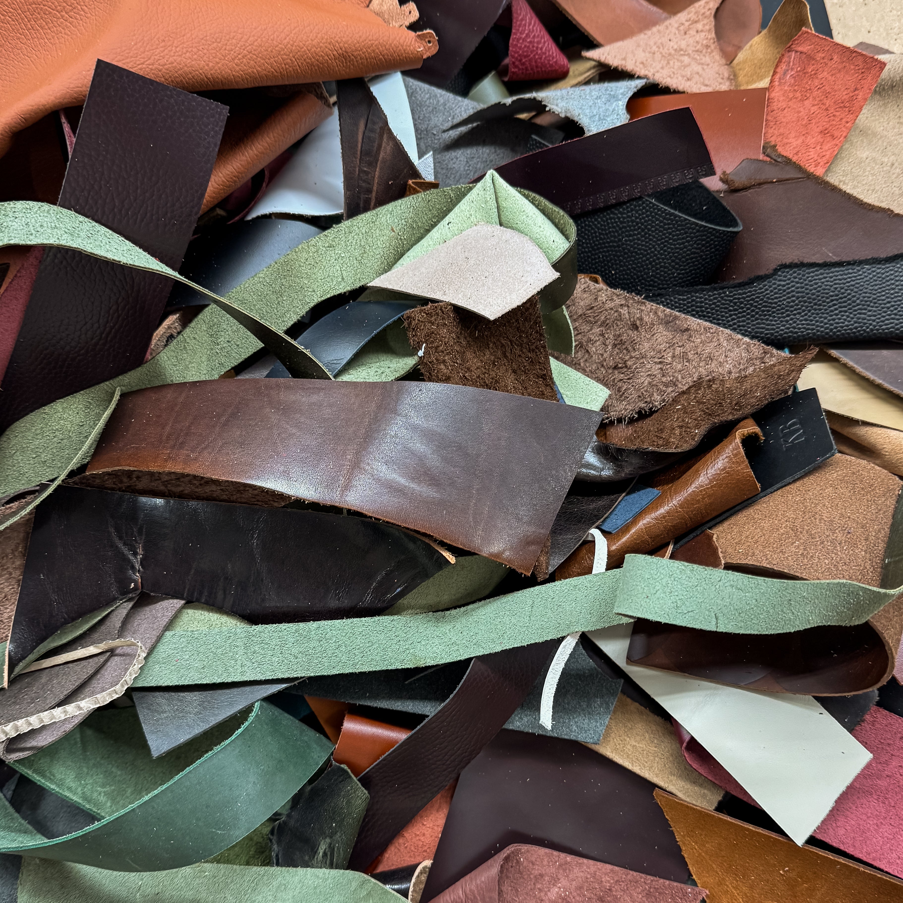 Assorted pieces of leather in various colors and textures.