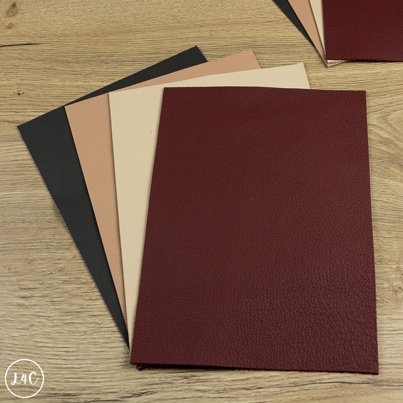 Set of leather panels in various colors on a wooden surface
