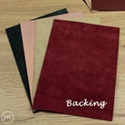 Collection of different leather sheets with 'Backing' text on a wooden surface