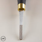 Metal tool with black handle and gold accent on a light gray background