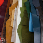 Collection of leather off cuts in various colors and textures.