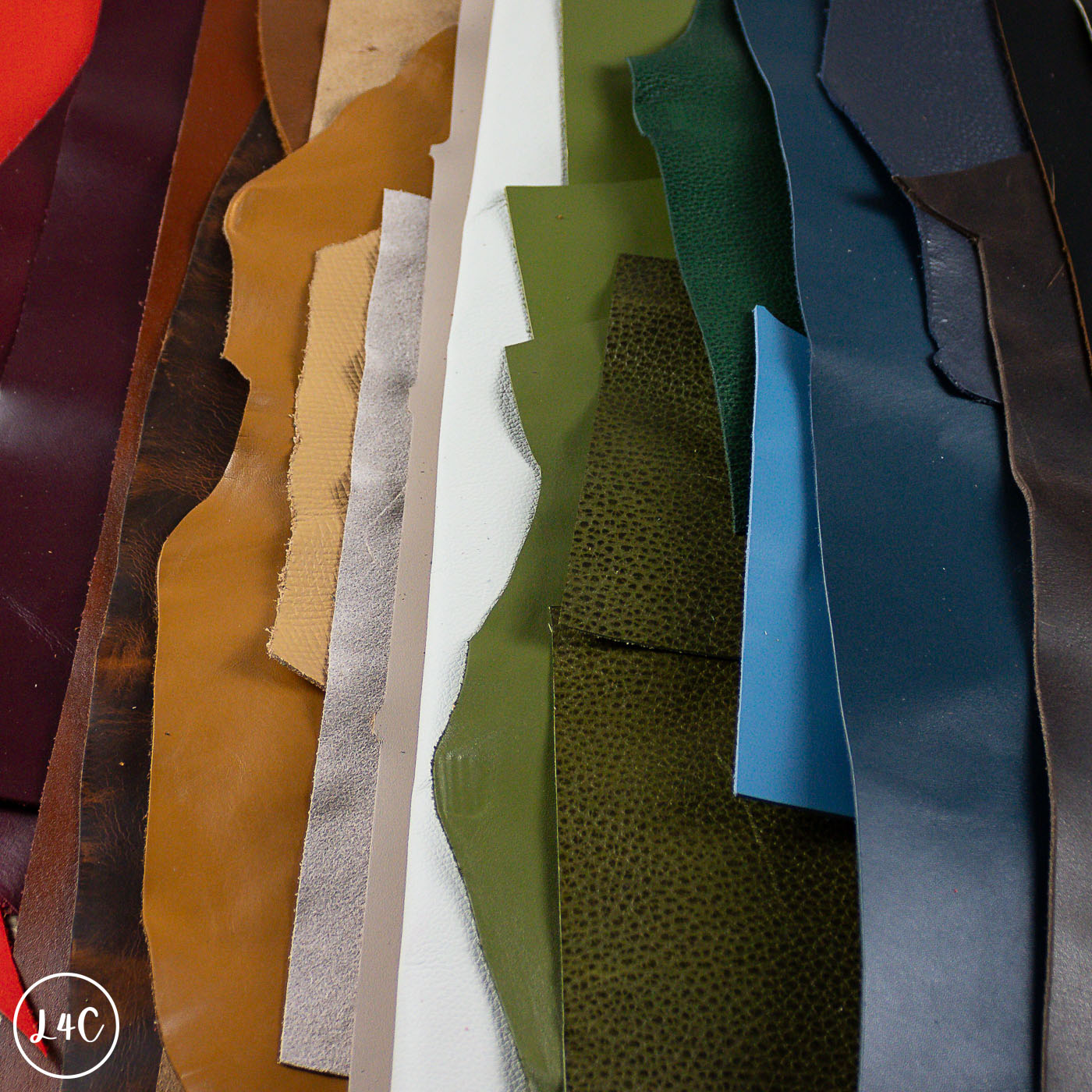 Collection of leather off cuts in various colors and textures.