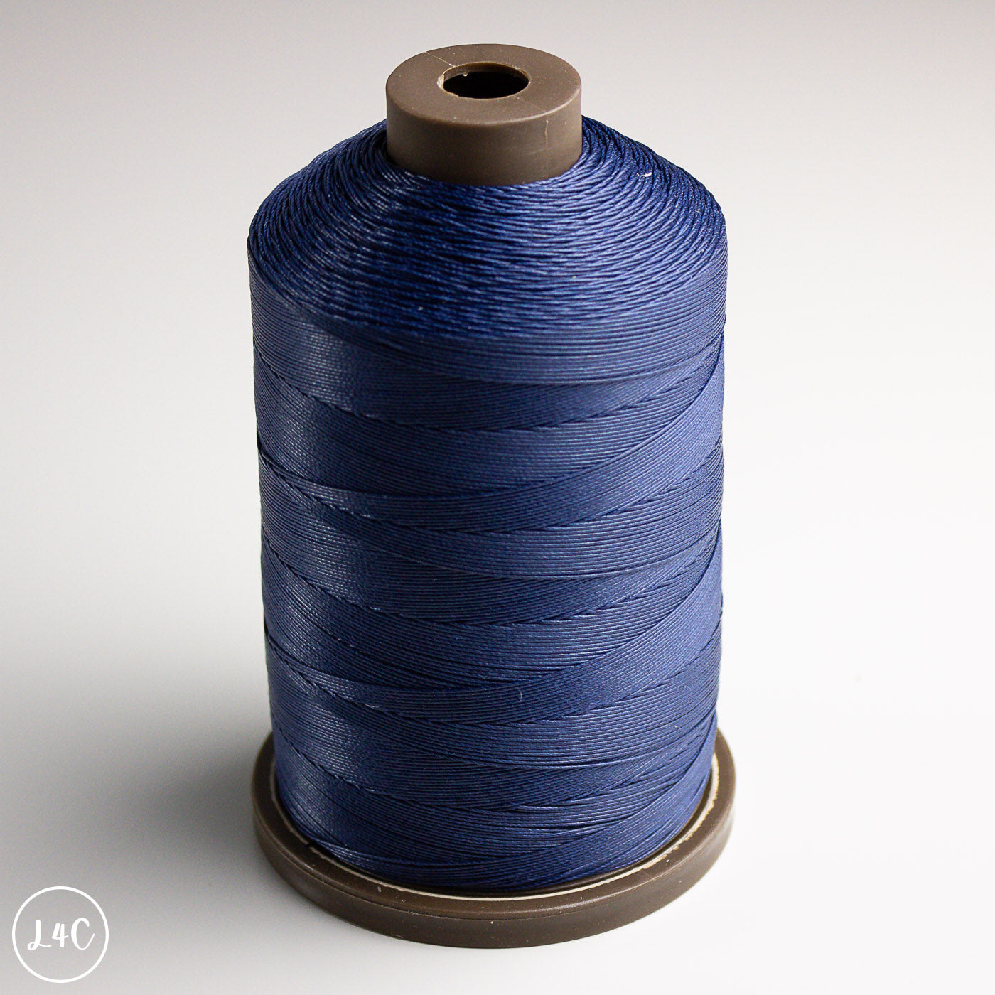 Spool of blue thread on a white background