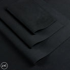 Black nubuck leather material folded neatly, showing a smooth matte texture.