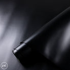 Close-up of a black leather hide surface with a soft focus