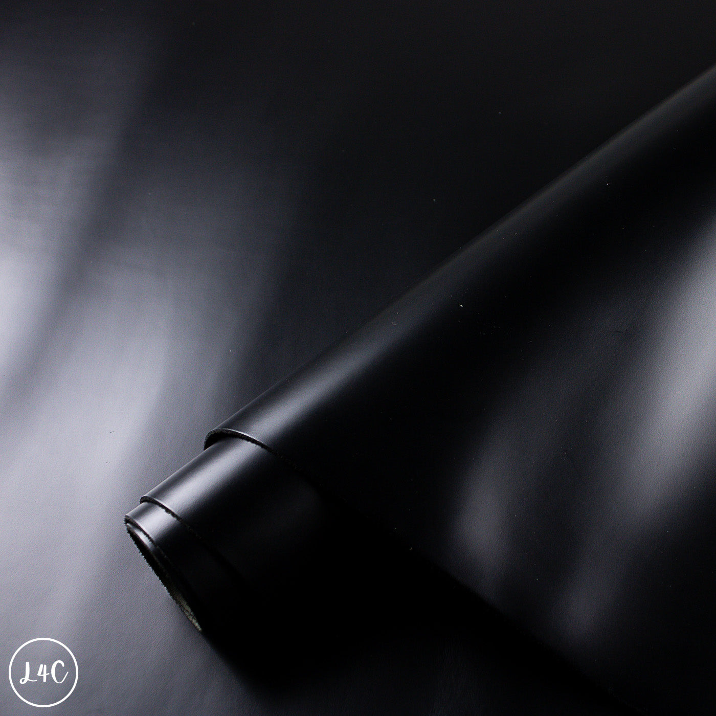 Close-up of a black leather hide surface with a soft focus
