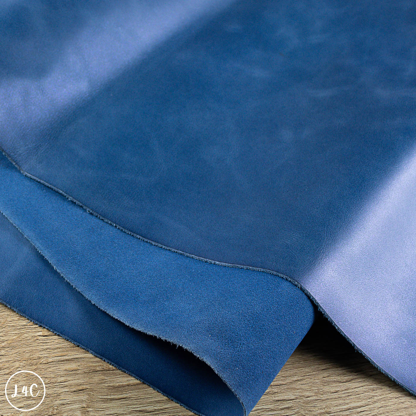 Close-up of blue leather fabric on a wooden surface