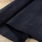 Dark blue leather on a wooden surface