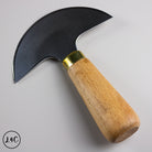 knife with wooden handle and gold accent on a gray background