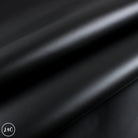 Close-up of black leather fabric with a subtle texture