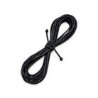 A coiled bundle of black elastic cords or straps tied in the center, photographed on a plain white background.