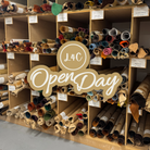 A wooden display shelf filled with rolled fabric or material samples in many colors, with a large overlaid badge reading 'L4C OpenDay'. 