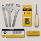Saddler's needles, threaders, and a bar of beeswax on a light gray background.