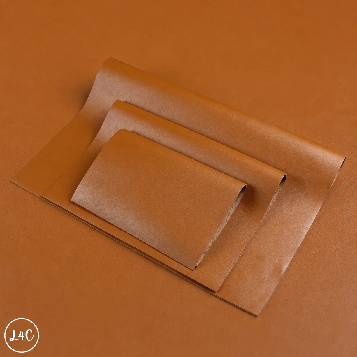Three sheets of warm brown kraft paper in different sizes, arranged diagonally on a matching brown background. 