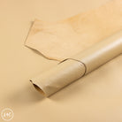 Rolled-up beige leather on a beige background