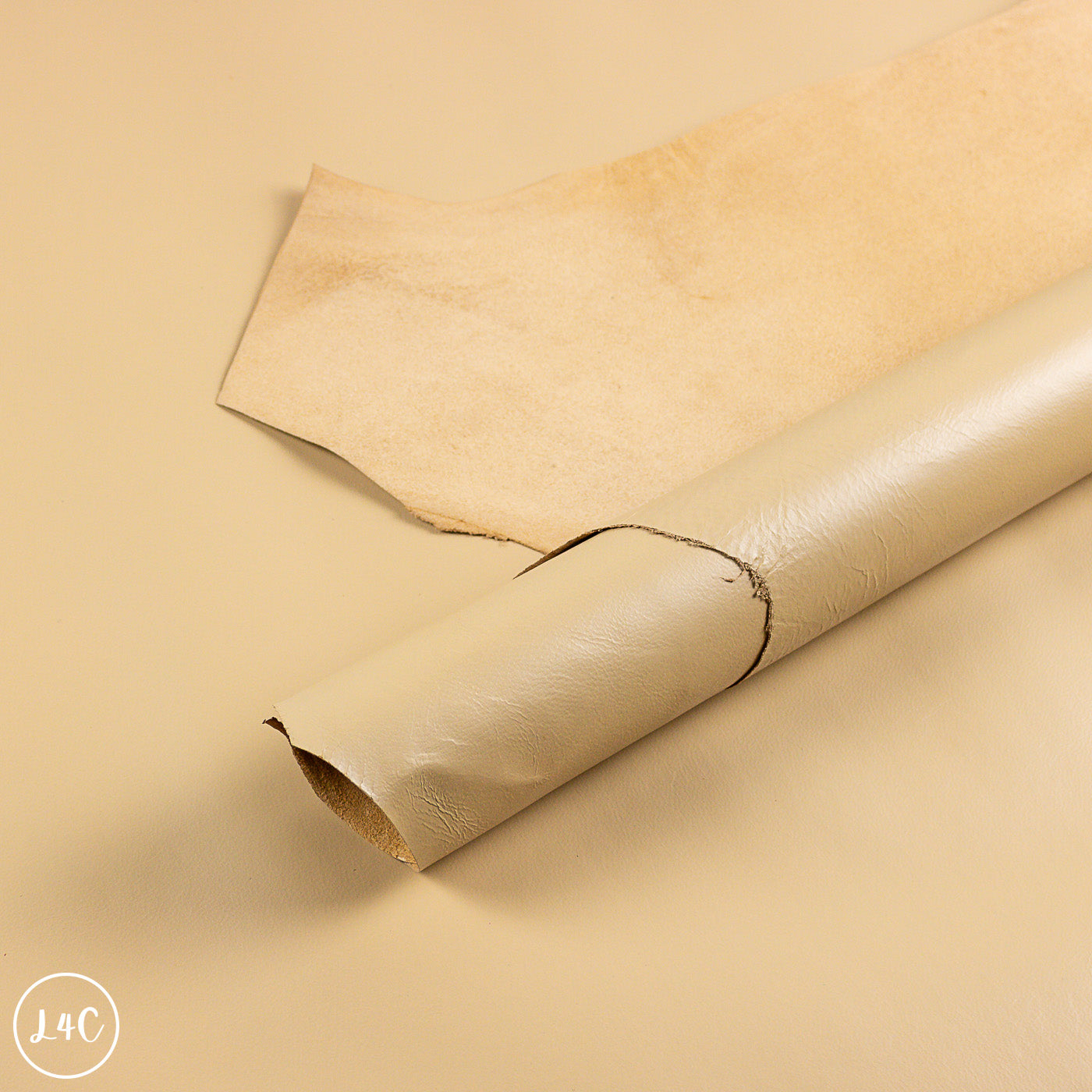 Rolled-up beige leather on a beige background