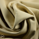 Close-up of beige leather with a soft texture