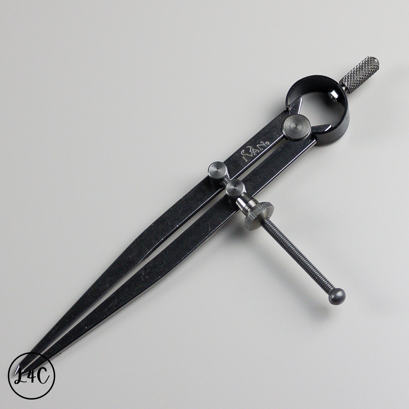 Black metal wing divider with adjustable components on a gray background