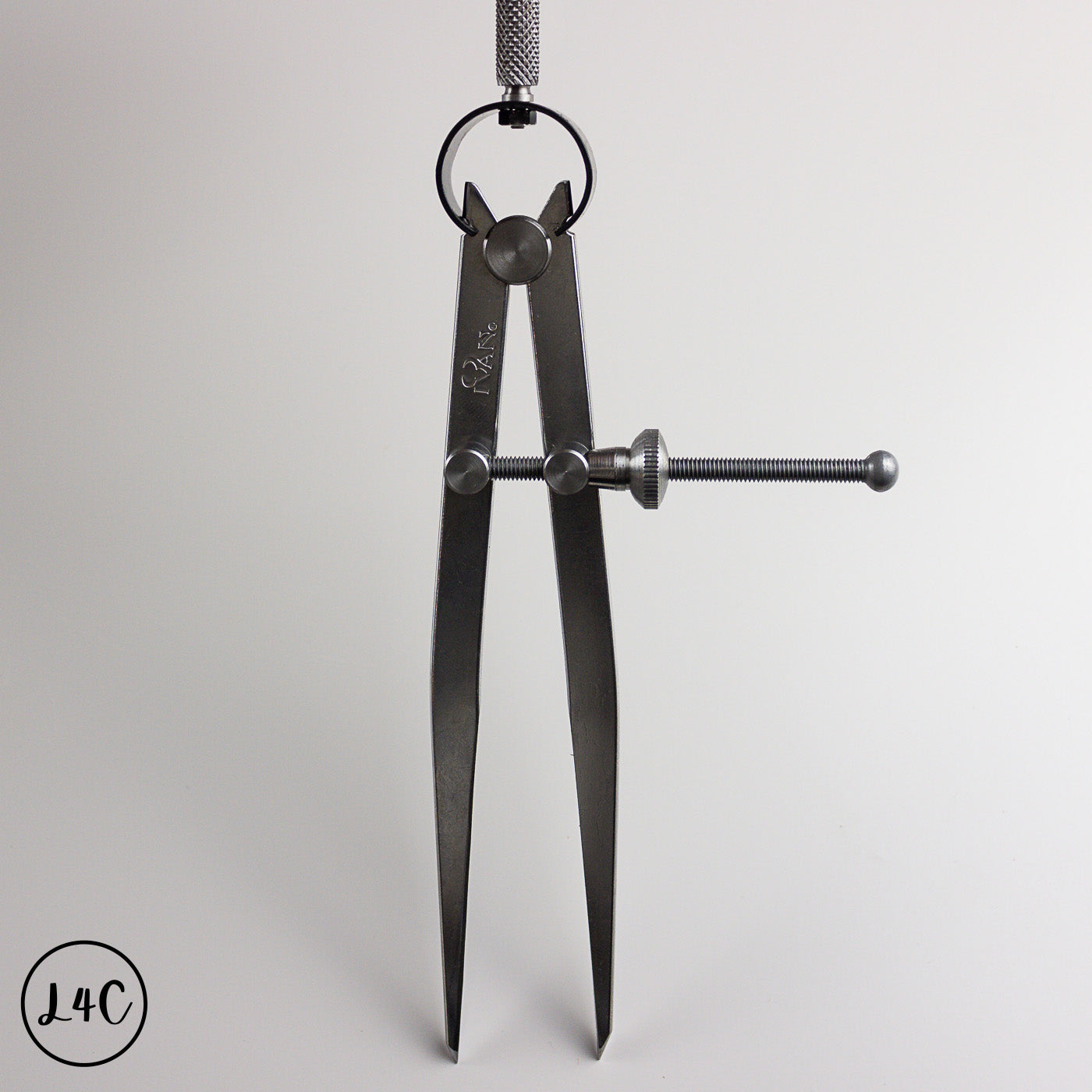 Black leather crafting tool on a light gray background