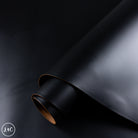 Dark black leather hide on a black background