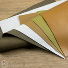 Collection of leather in various colors on a wooden surface