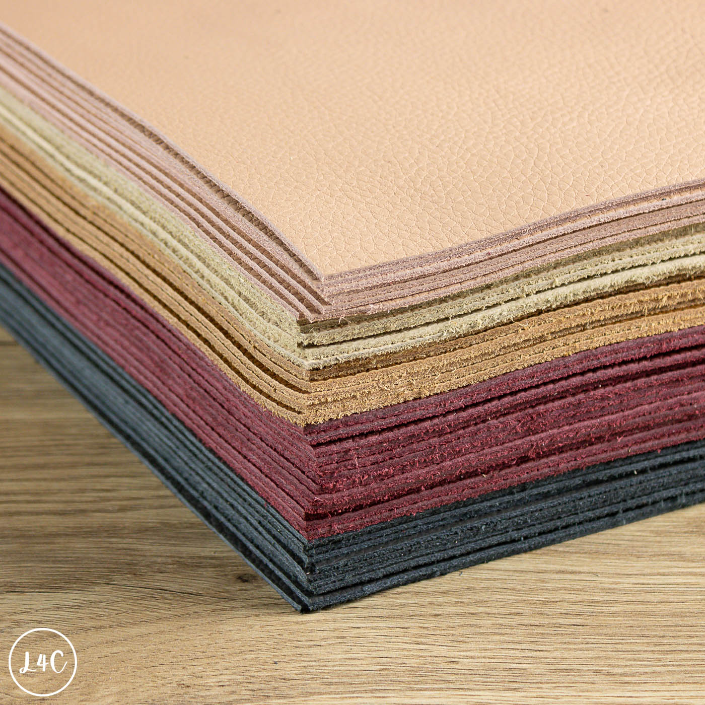 Stack of colorful leather panels on a wooden surface