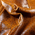 Close-up of brown leather Ostrich Embossed Tan Leather Hide with perforated design