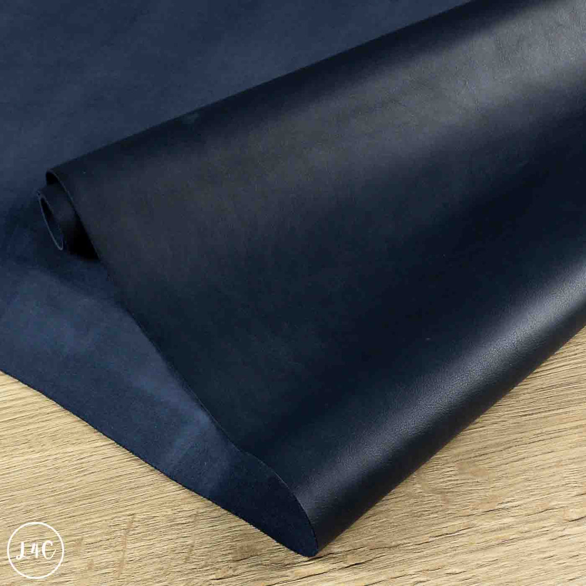 roll of blue leather on wooden background